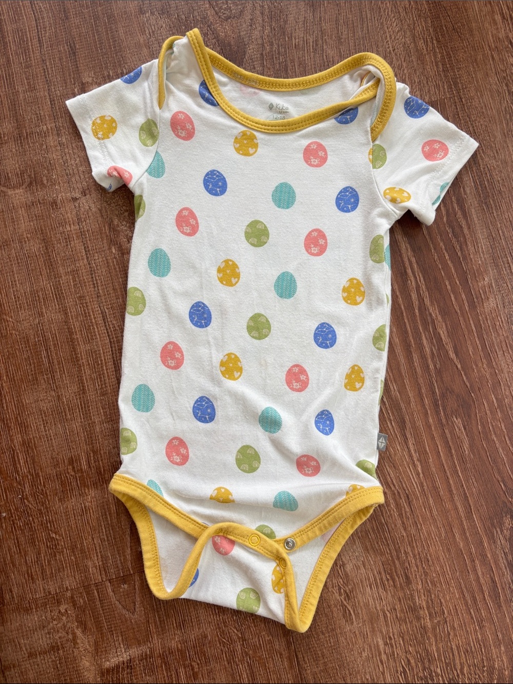 Kyte BABY White One-Piece Bodysuit with Multicolor Easter Eggs and Yellow Trim